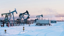 Oil Field. Winter industrial landscape with an oil pump and torch in the background. Oil Field. Winter industrial landscape with an oil pump and torch in the background.